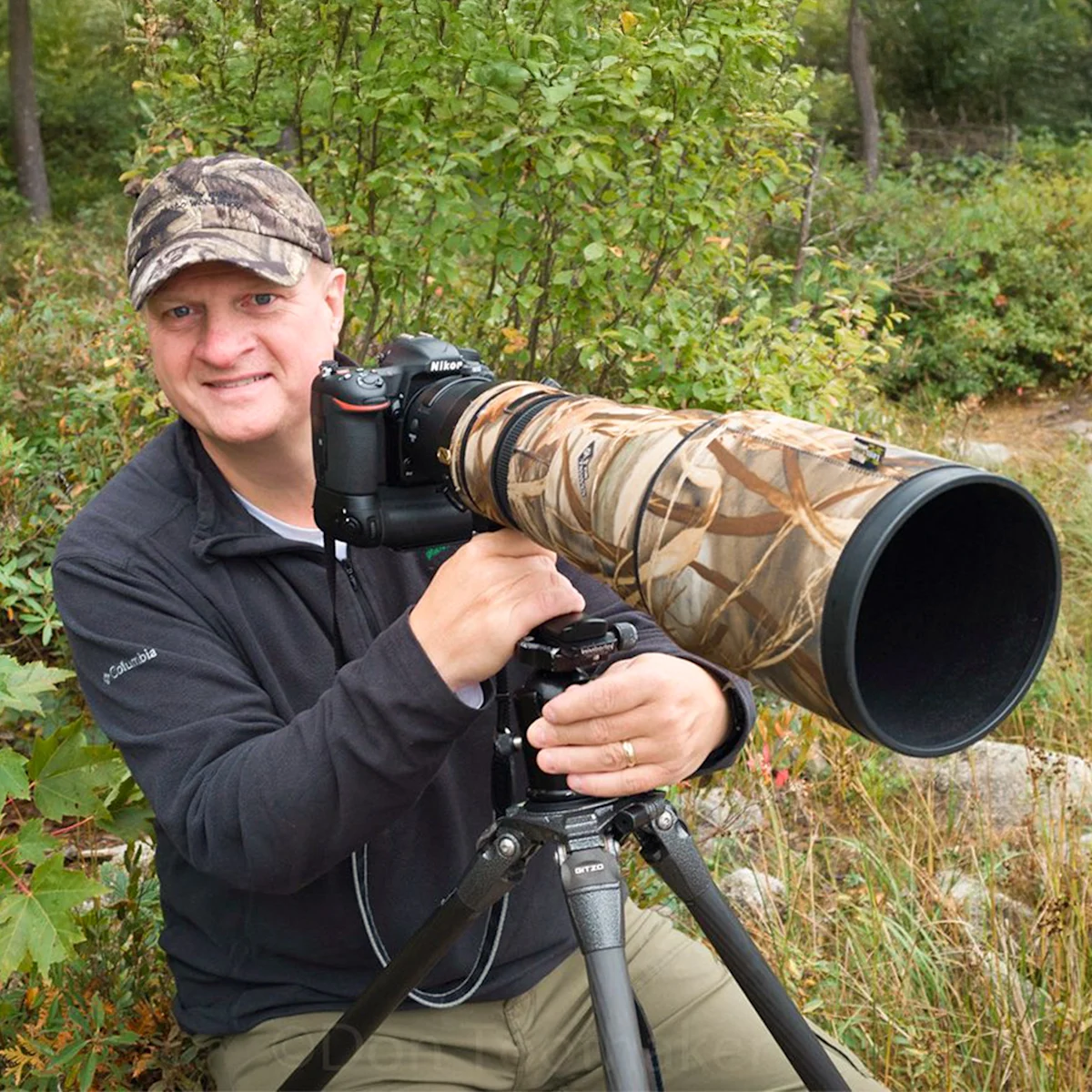 Portrait of Don Toothaker with a camera and long lens on a tripod