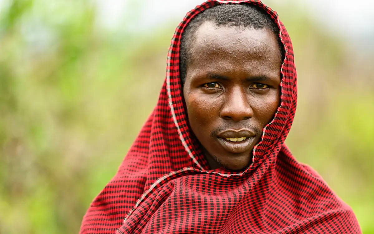 Portrait of a Maasai man wrapped in a red checked shuka