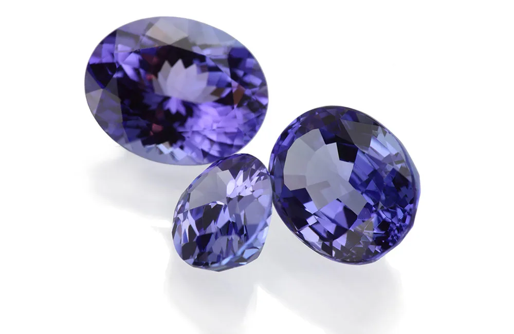 Three faceted violet-blue tanzanite gemstones