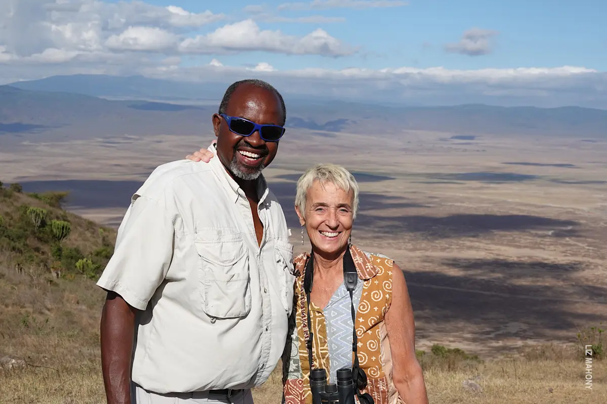Guide and traveler smiling at a viewpoint above Ngorongoro Crater