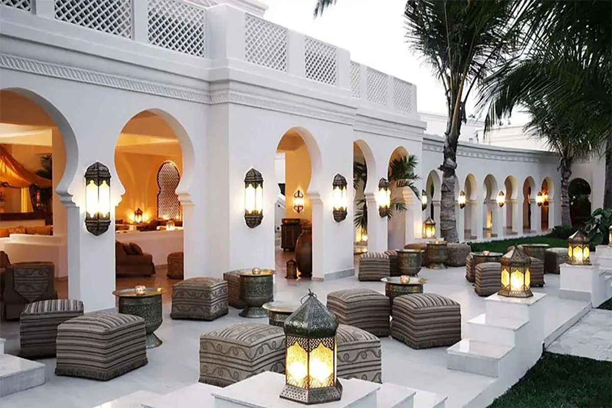 Arched white terrace with lanterns and cushioned seating at Baraza Resort & Spa
