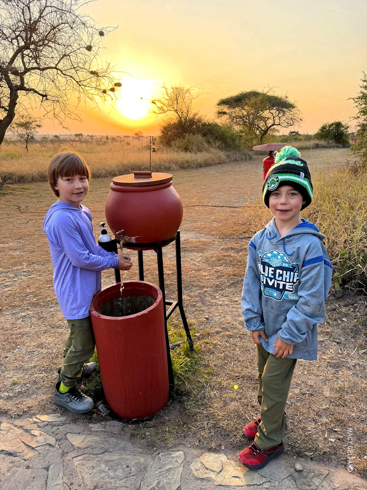 boys washing hands outside dining tent at thomson serengeti nyumba camp