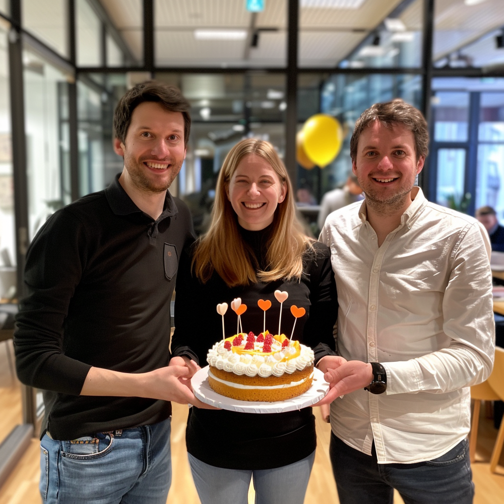 Colleagues celebrating a work anniversary with a cake