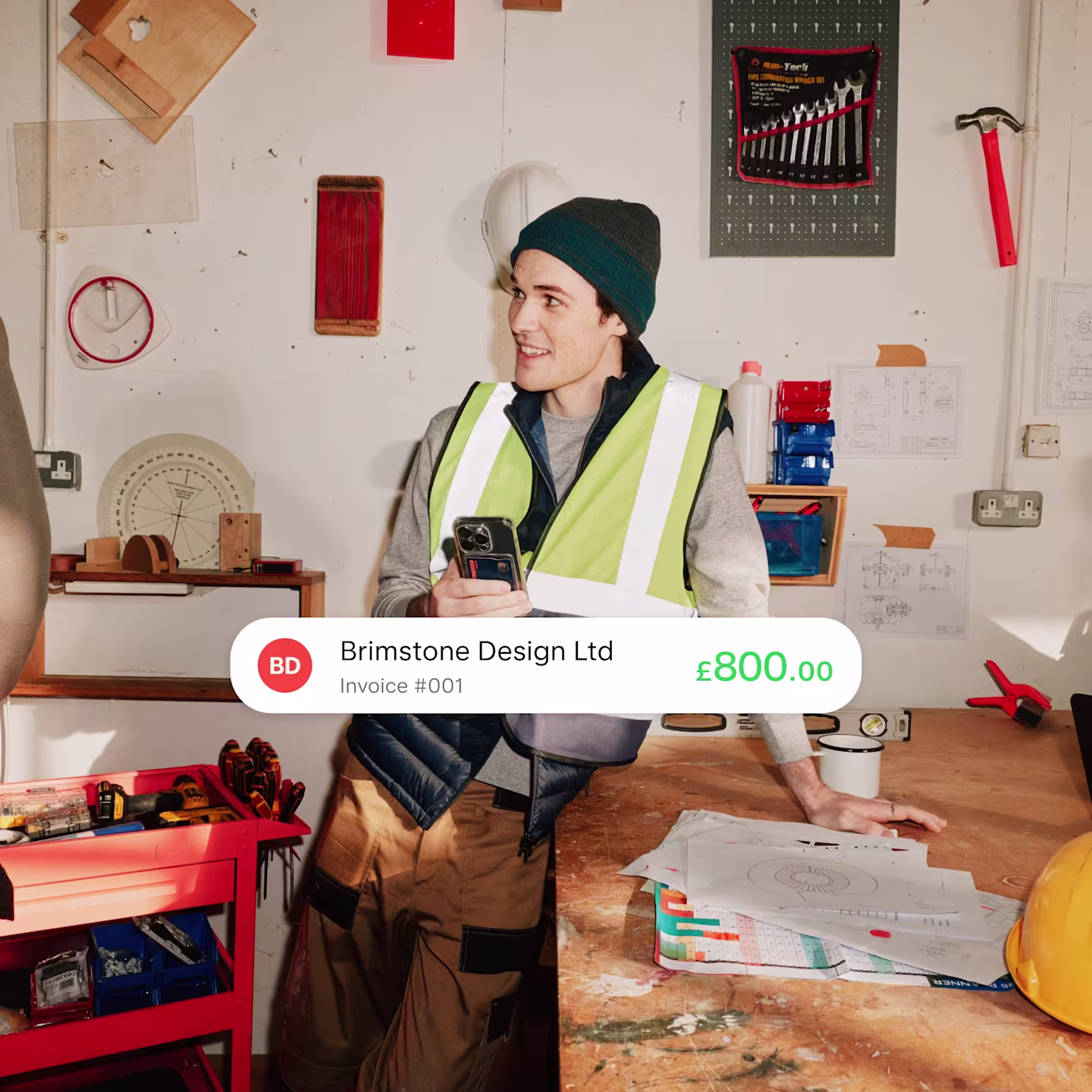 A picture of a construction business owner with an app payment notification overlaid