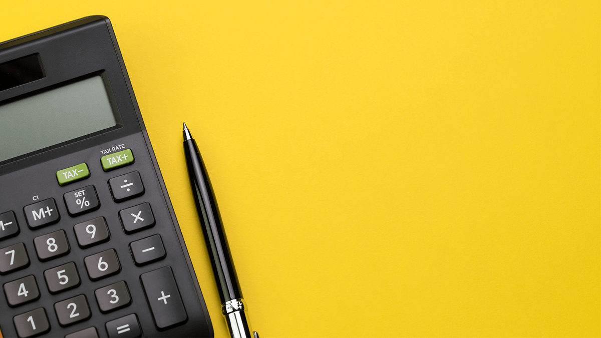 photo of calculator and pen on a yellow background