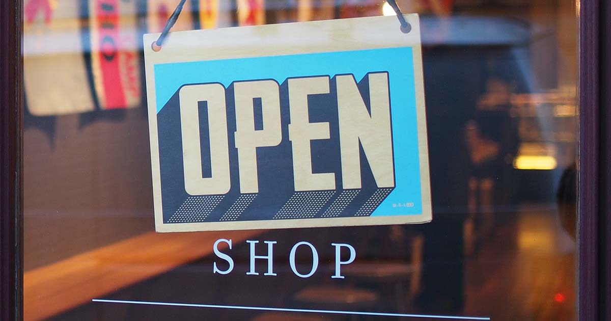 A shop sign saying open