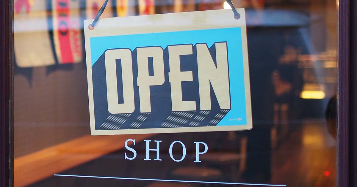 A shop sign saying open