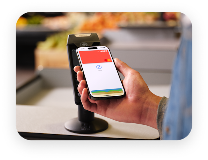 Person paying with their Monzo card with Apple Pay. 