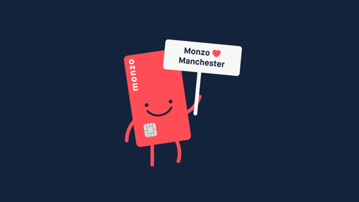 hotchip holding sign "Monzo loves Manchester"