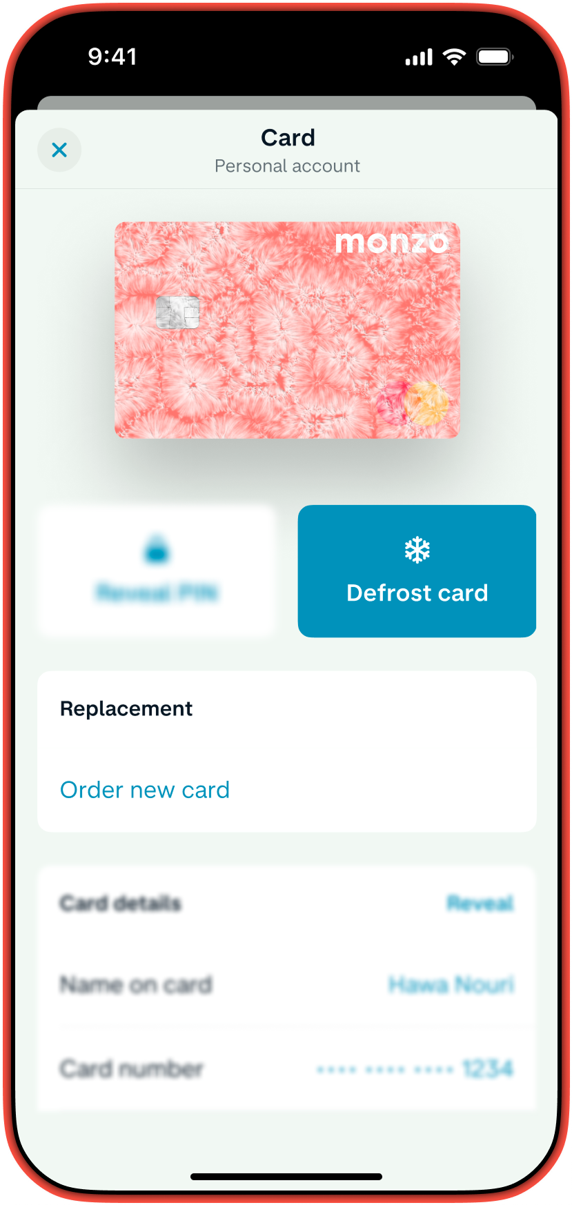 A smartphone screen shows the Monzo app's card management page, displaying a hot coral card and option to freeze card or order a replacement card.