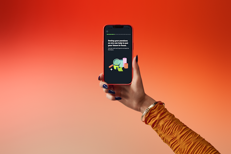 A hand in an orange patterned sleeve holds a smartphone displaying a dark screen with white text and colorful graphics, against a red-orange gradient background.