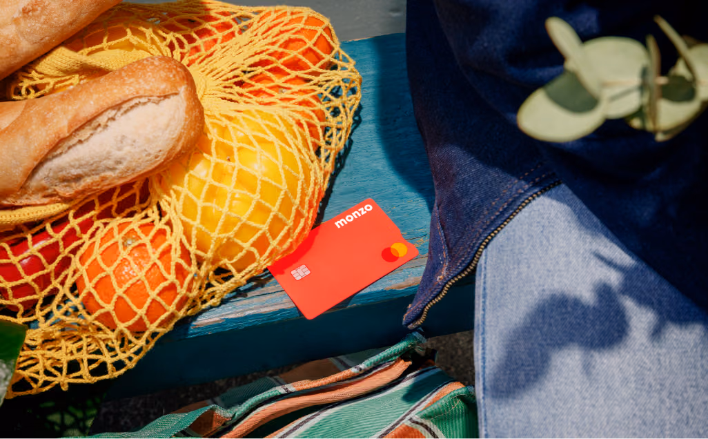 A close-up of a Monzo card next to some groceries.