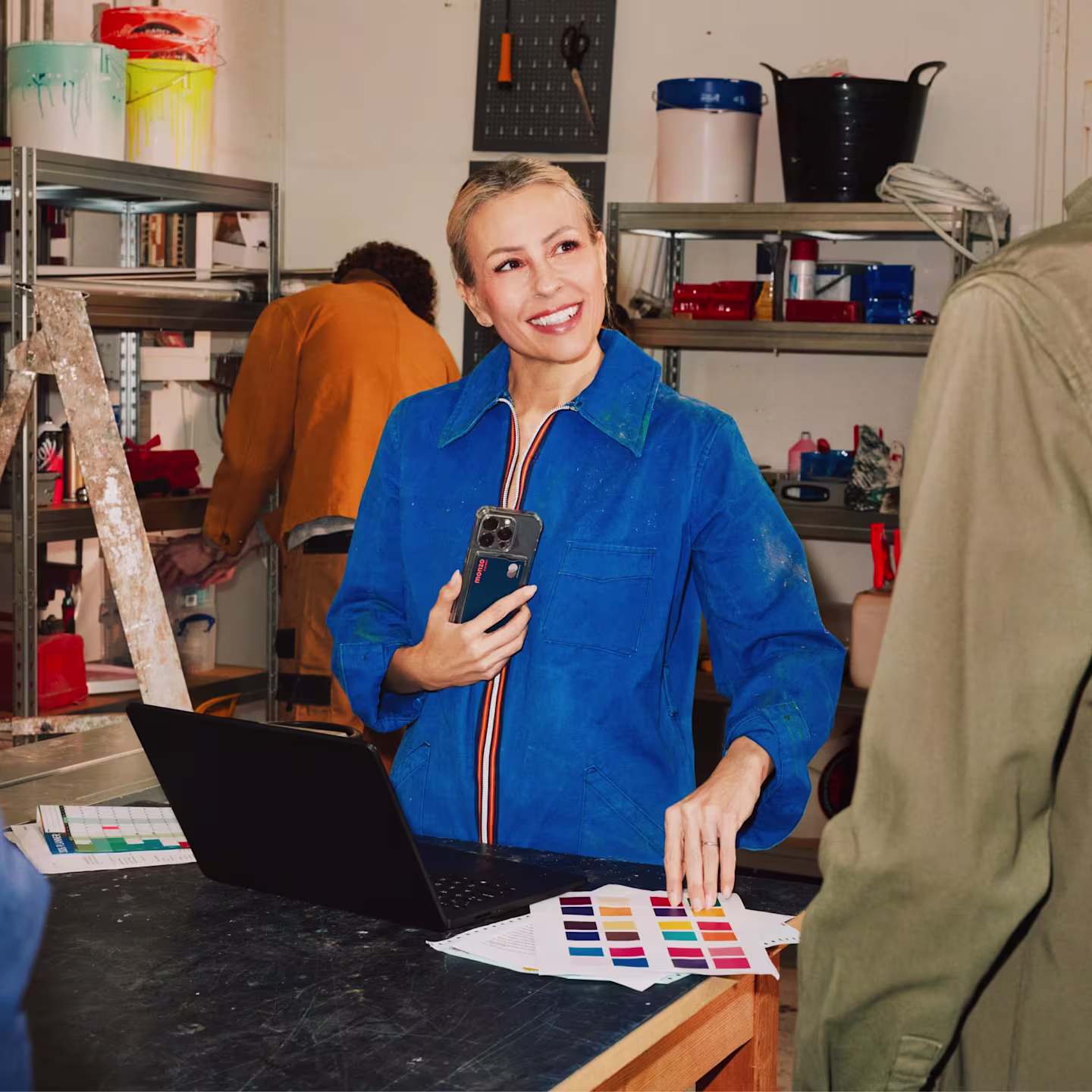 A business owner talking to a customer with a Monzo Business bank card in the back of her phone