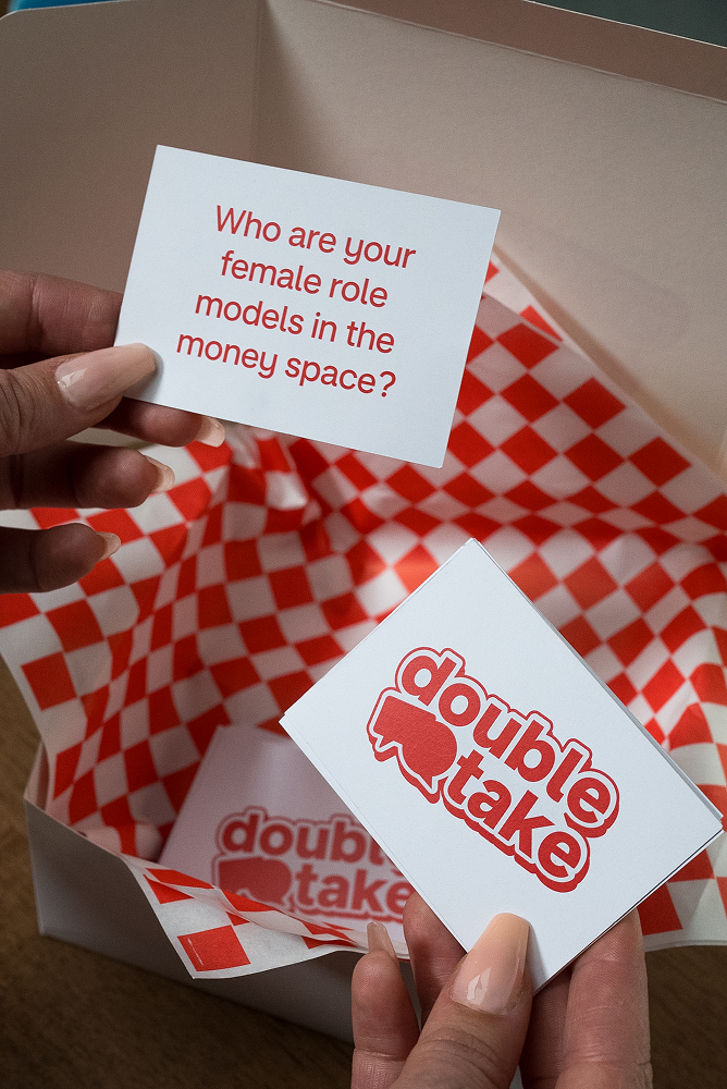 Hands holding a cue card, with the question 'Who are your female role models in the money space?'