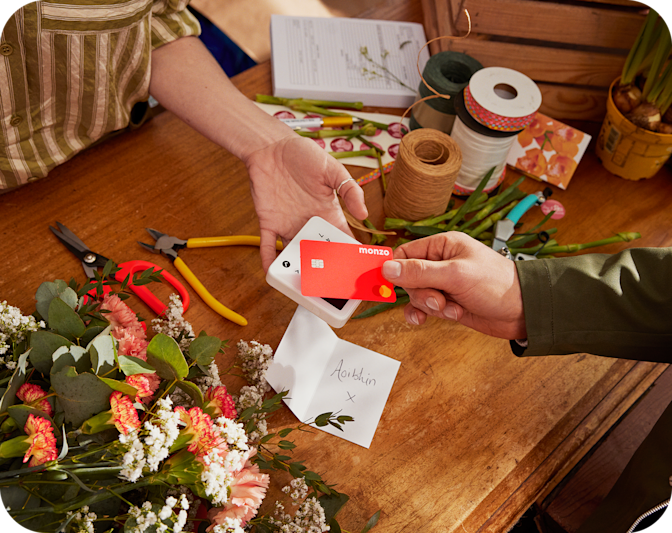 Hot Coral Card tapping to pay at a local florist