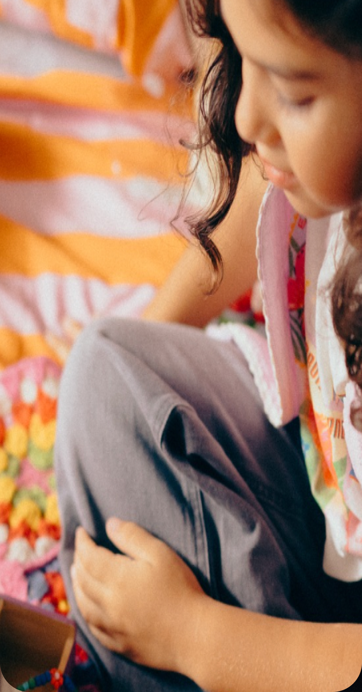 Image of a young girl playing on her bed. 