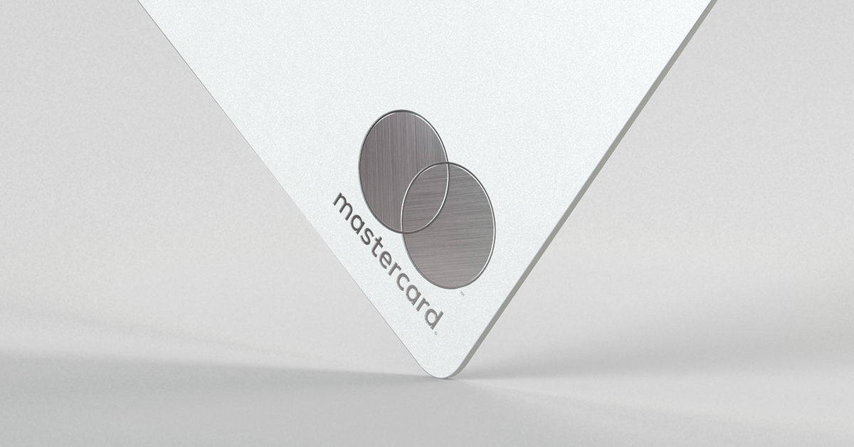 A close-up of the engraved Mastercard logo on a metal Monzo card