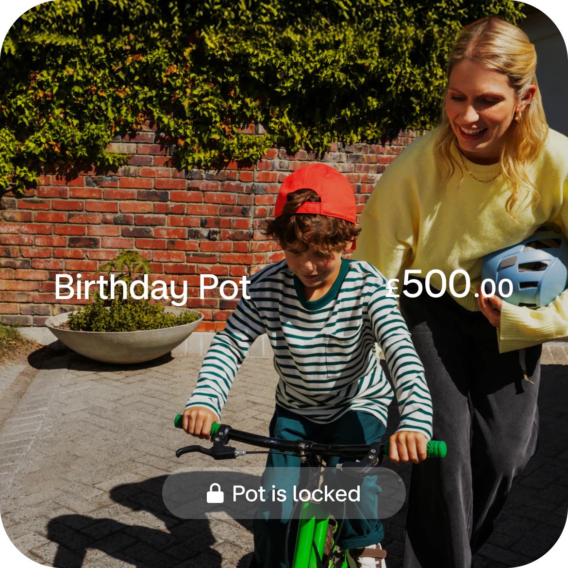 Little boy riding a bike with his parent. 