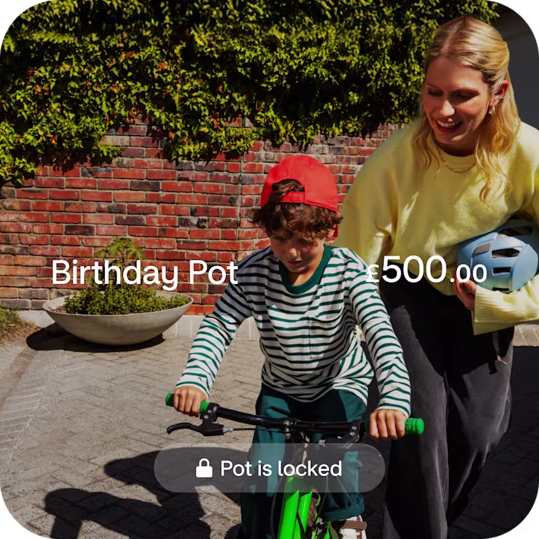 Little boy riding a bike with his parent.
