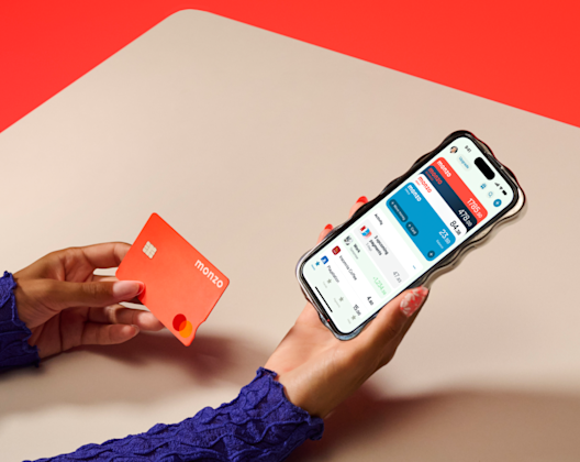 Person on phone holding hot coral card