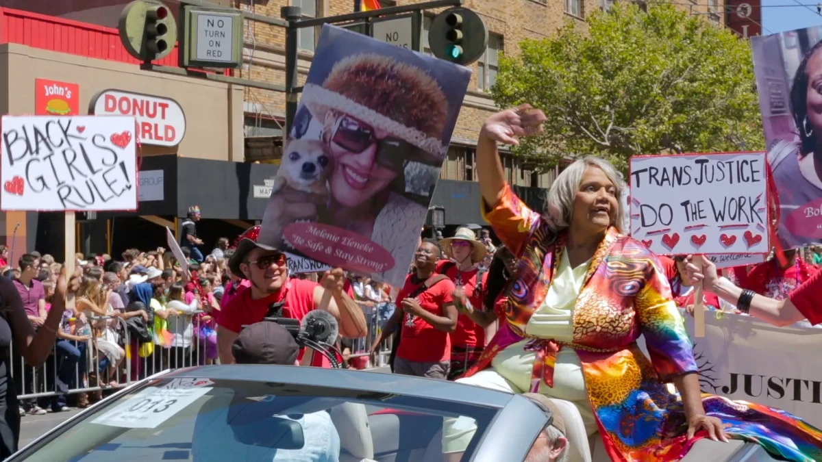 Miss Major Griffin-Gracy waving from a car in a parade