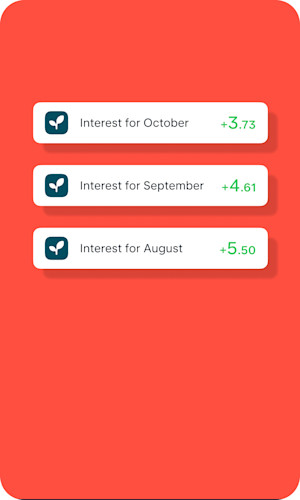 A hand holding a card in front of buildings