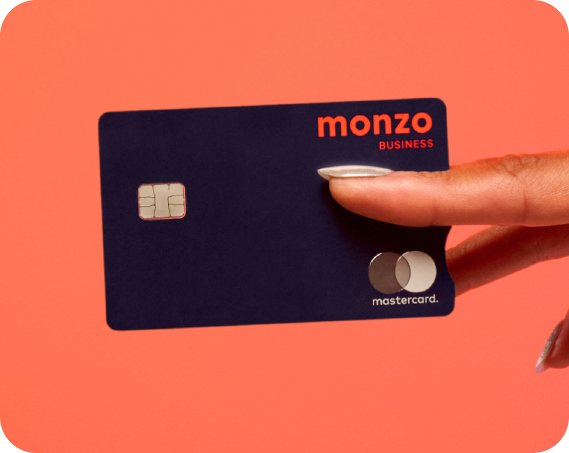 Close up of a monzo business debit card between fingers