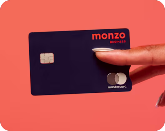 Close up of a monzo business debit card between fingers