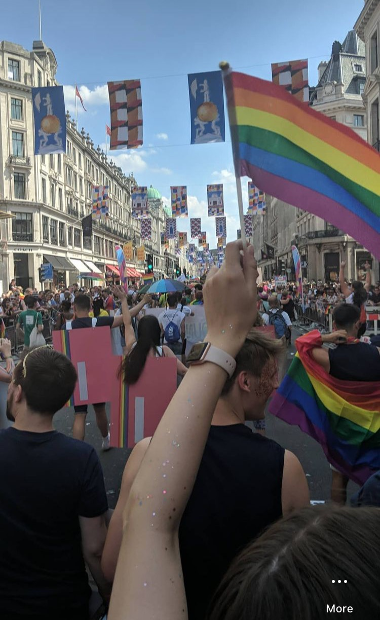 Monzonauts celebrating Pride in London, dressed as Hot Coral bank cards, and waving flags.
