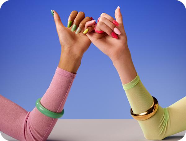Hands with bright coloured nails – pinky fingers linking 