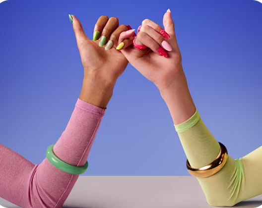 Hands with bright coloured nails – pinky fingers linking
