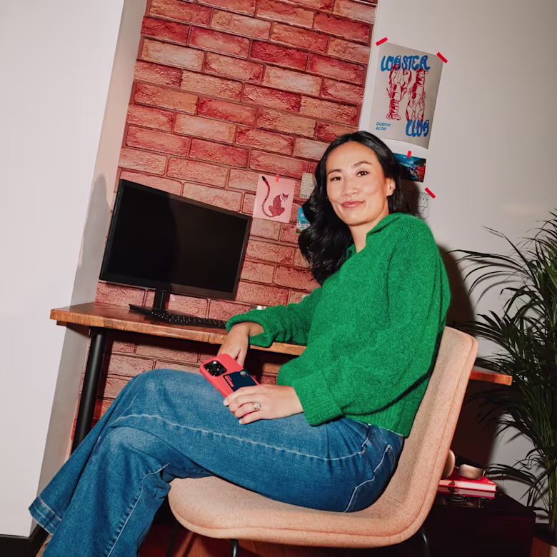 A business owner sitting at her desk in front of a computer