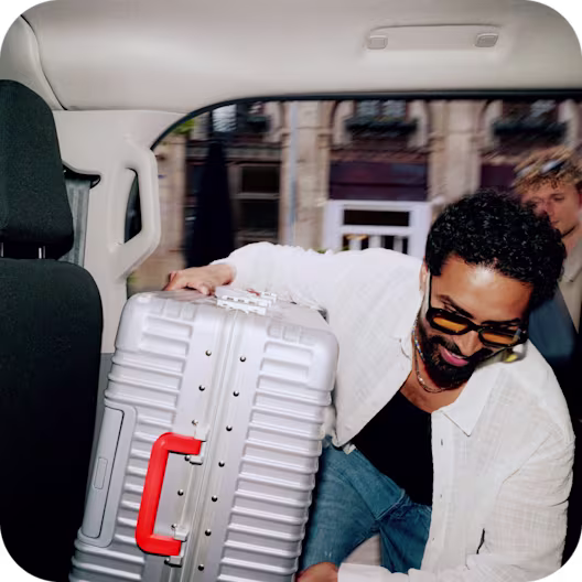 A man carries a suitcase