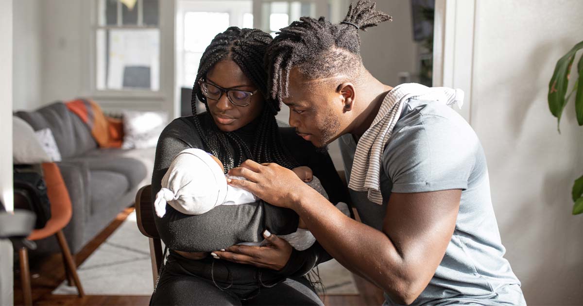 A couple holding a small baby