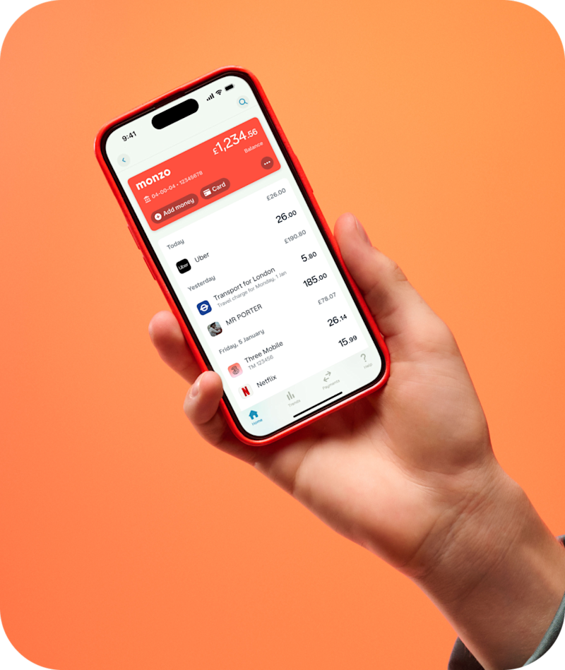 Shot of the Monzo UI in a hand against a orange gradient