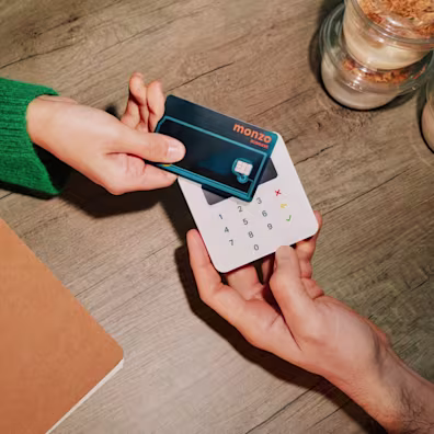 An employee tapping their Monzo Business expense card to pay for a purchase