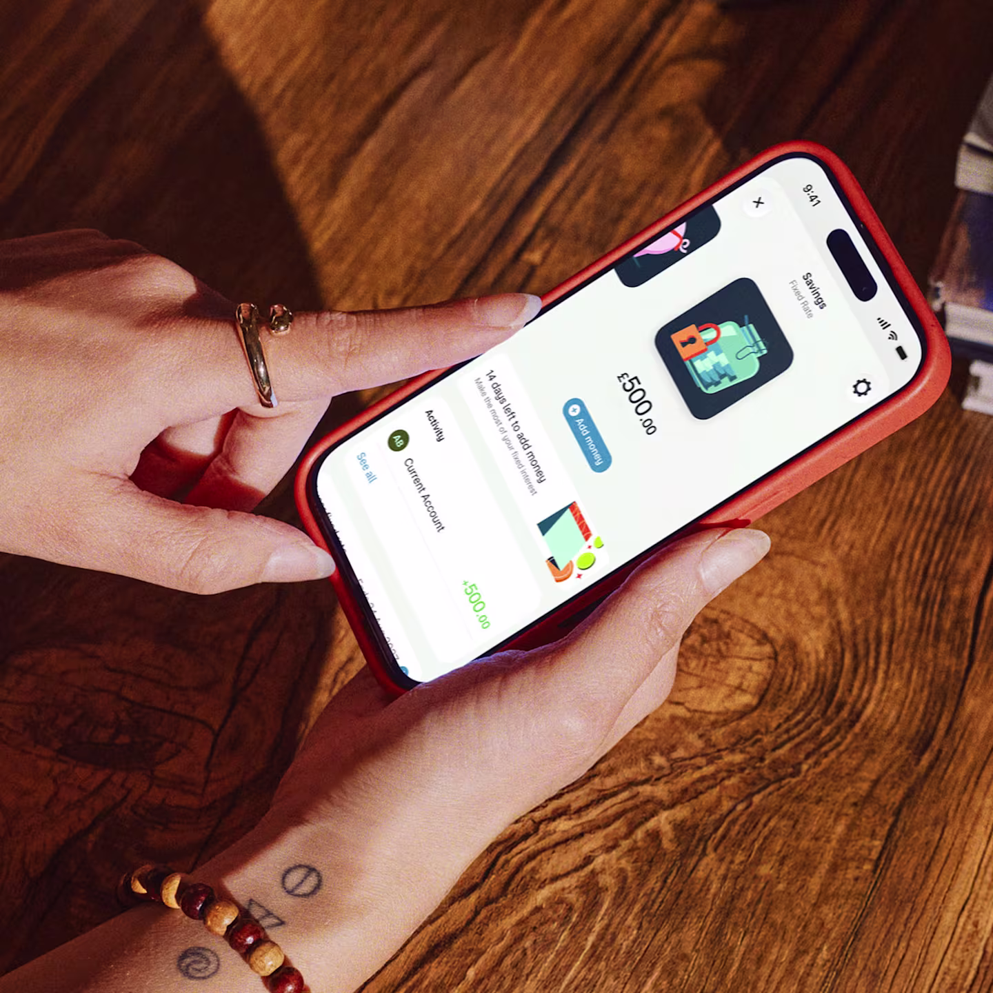 A zoomed in view of a smartphone in someone's hands showing the user interface of an open fixed rate savings pot.