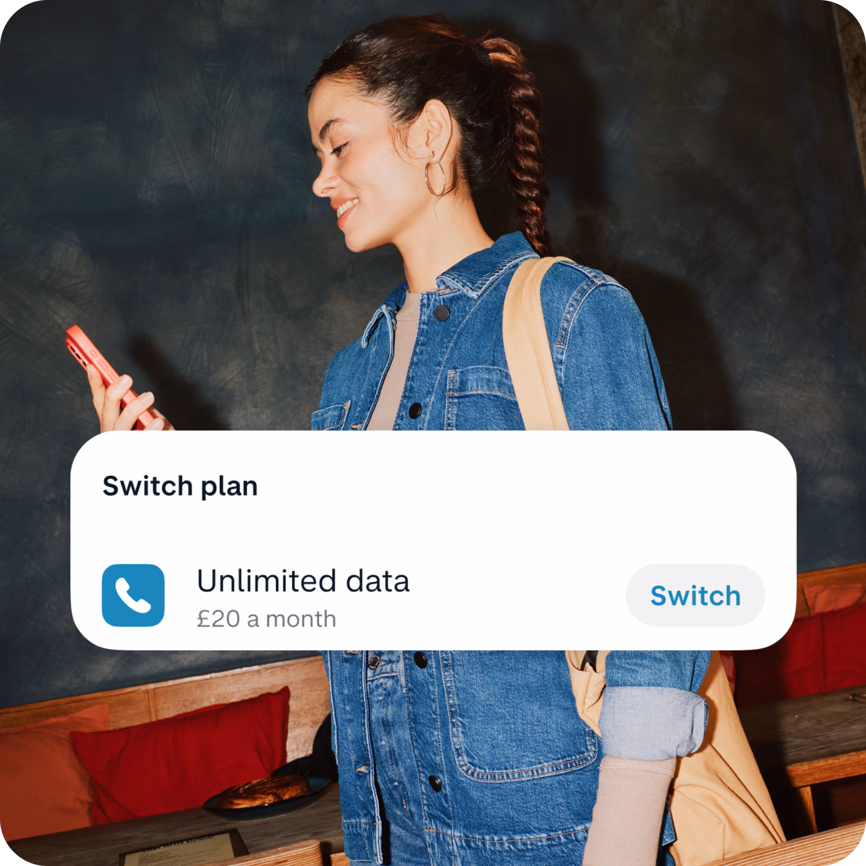 A woman is looking at her phone, with the screen showing an option to switch her mobile plan in app