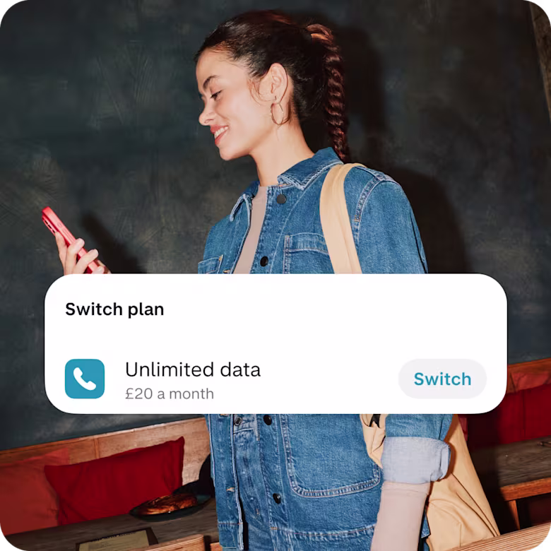 A woman is looking at her phone, with the screen showing an option to switch her mobile plan in app