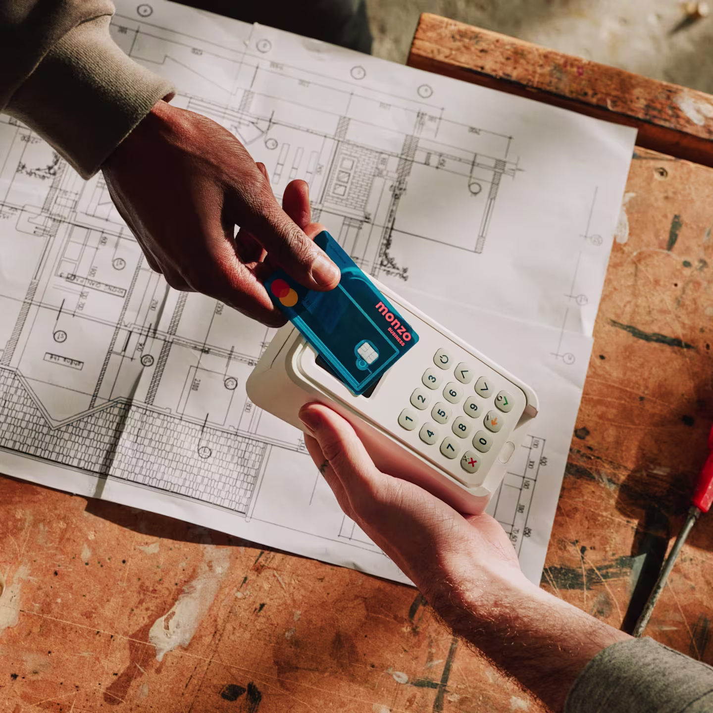 A business owner paying via contactless with a Monzo Business card