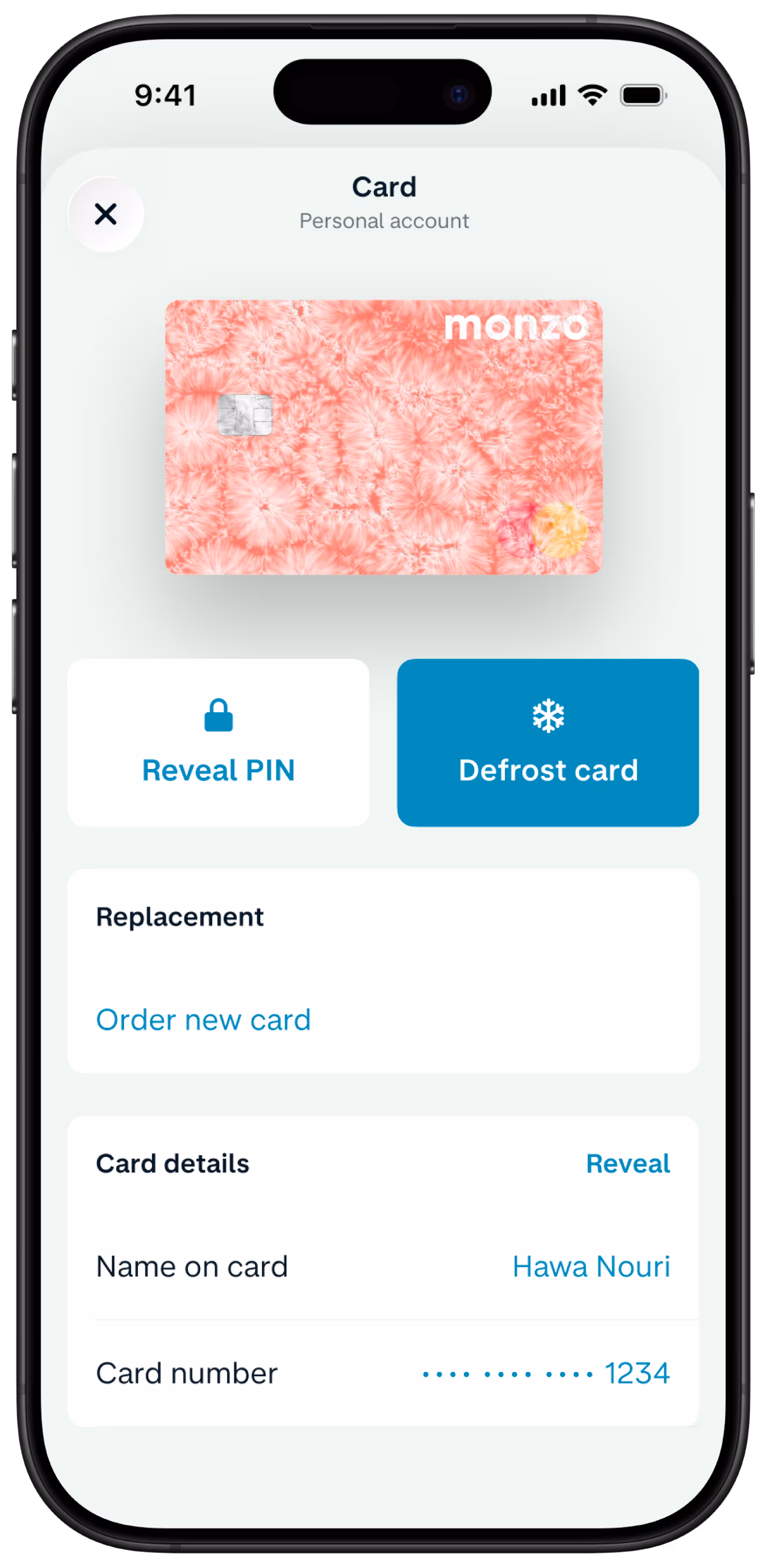A smartphone screen shows the Monzo app's card management page, displaying a hot coral card and option to freeze card or order a replacement card.