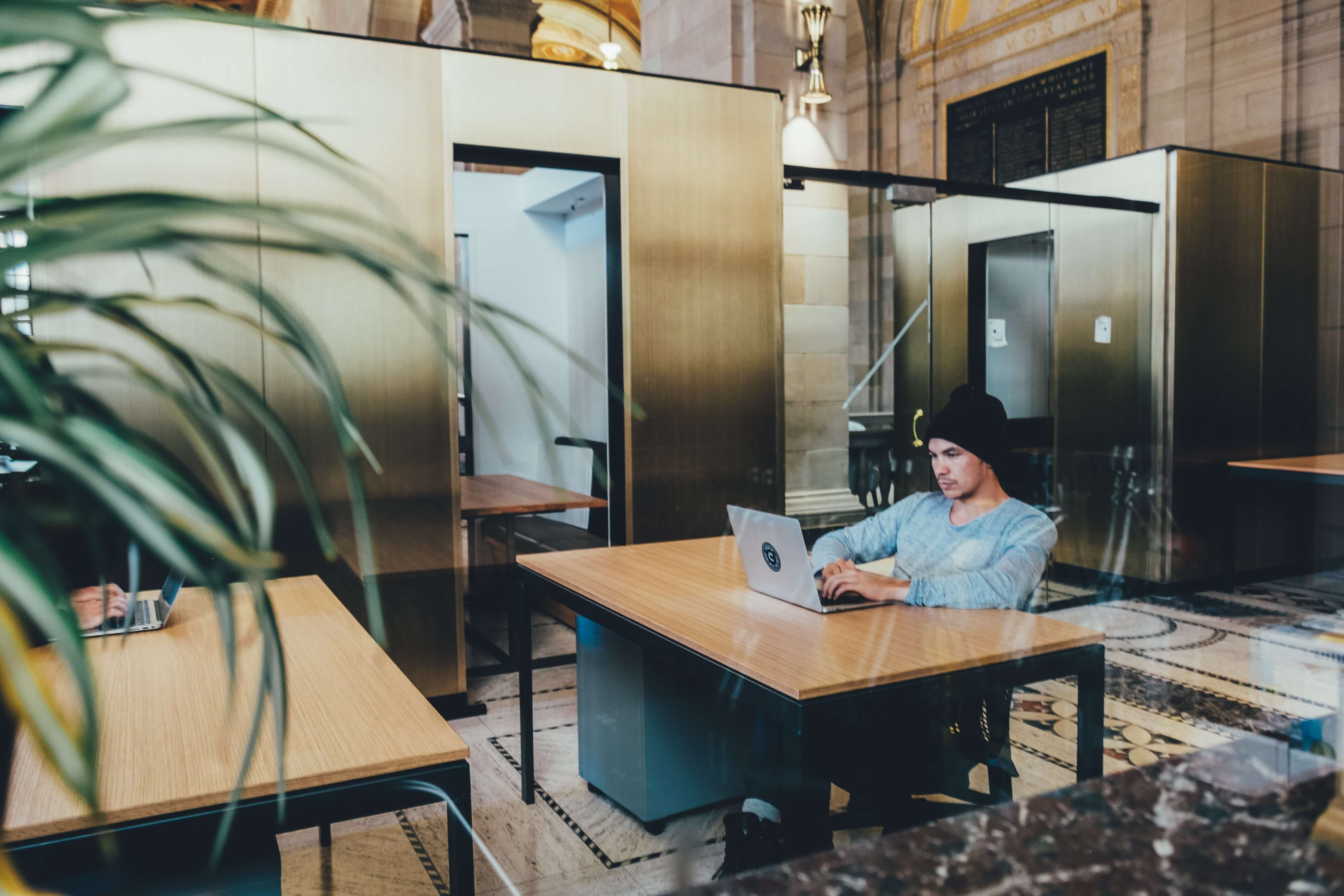 A man working on a laptop in a modern looking office