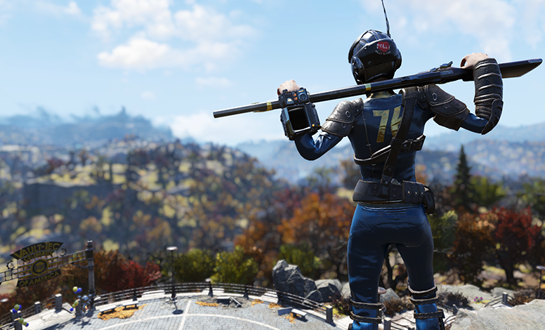 A Fallout 76 character in a blue jumpsuit with '76' on the back stands on a rocky ledge, holding a rifle. They're wearing a helmet and armor, with mountains and autumn trees in the background. A 'Vault 76' sign is visible in the lower left corner
