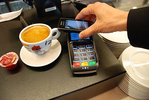 Homme payant avec un portefeuille numérique à l’aide d’un appareil mobile