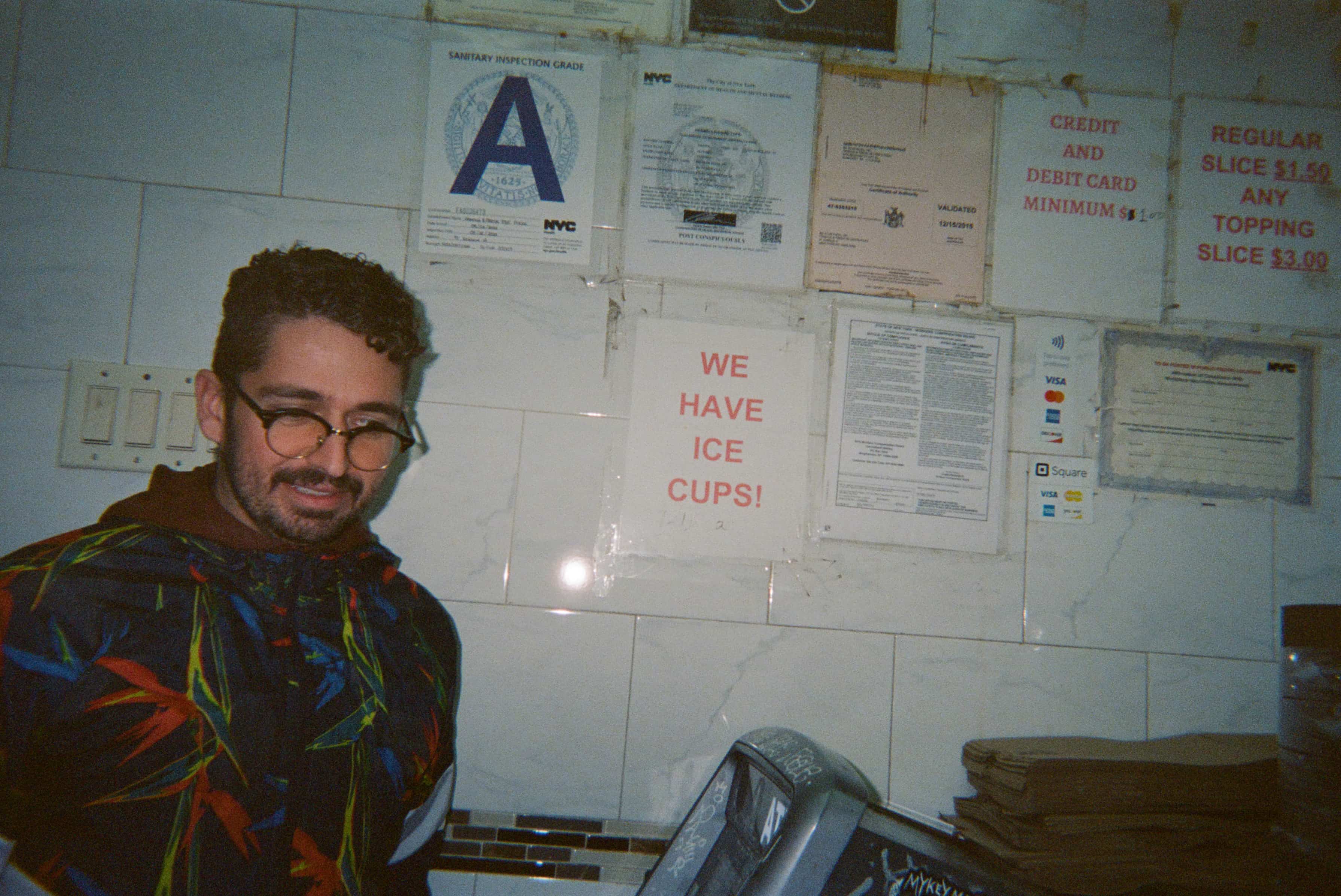 A person standing in front of a wall with signs.