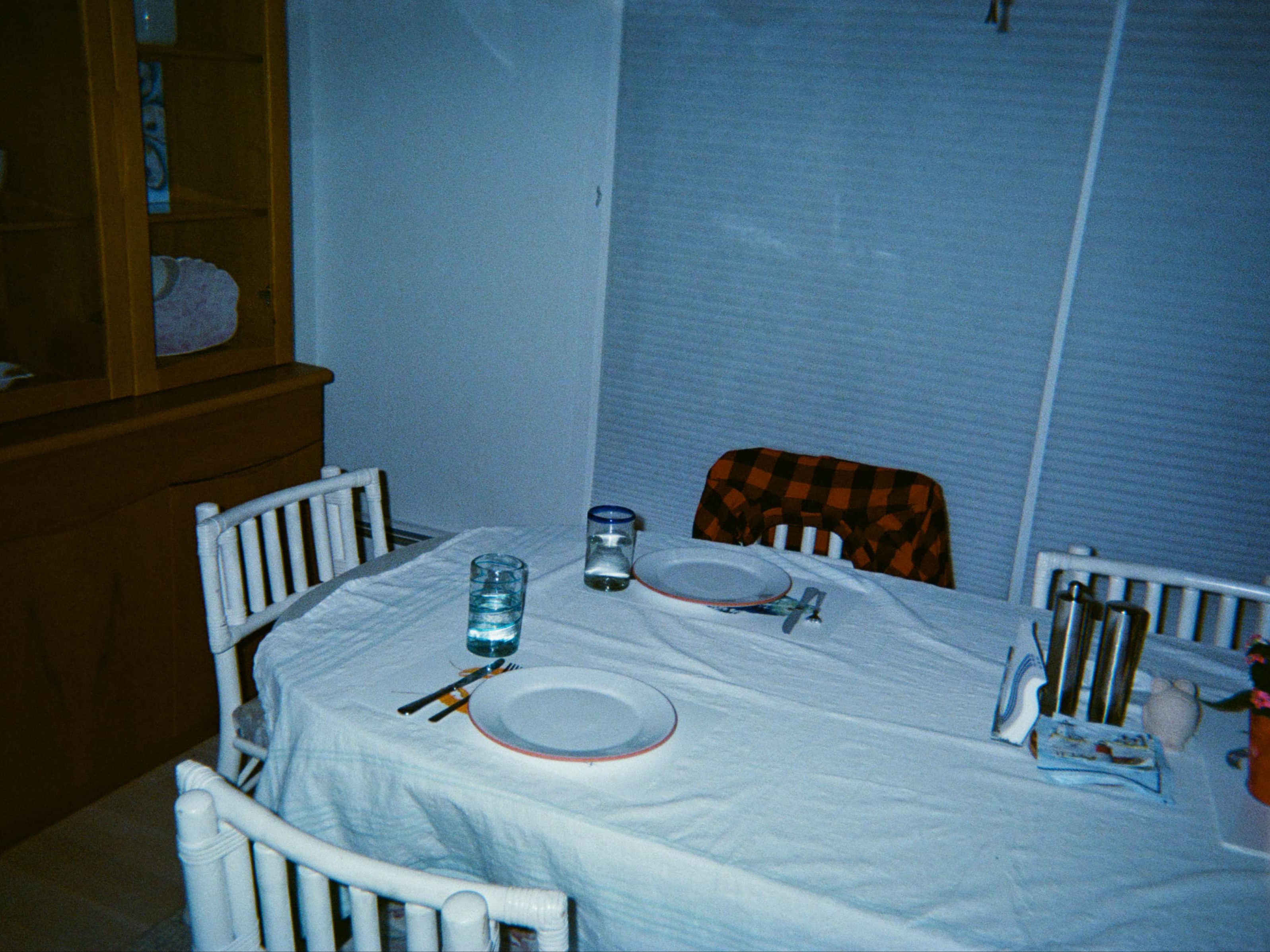 A table with plates and glasses of water on it.