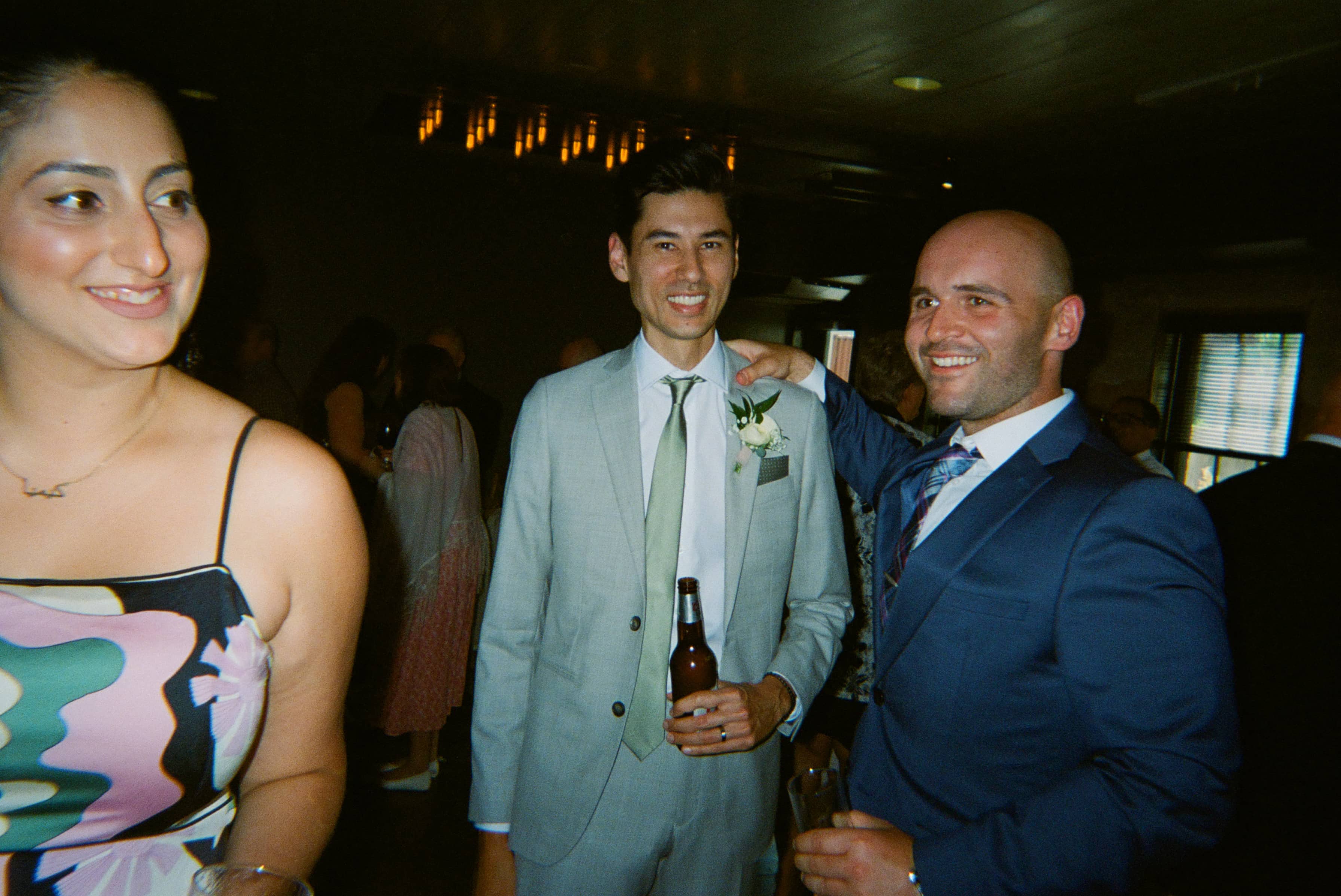 Three people in formal wedding attire.