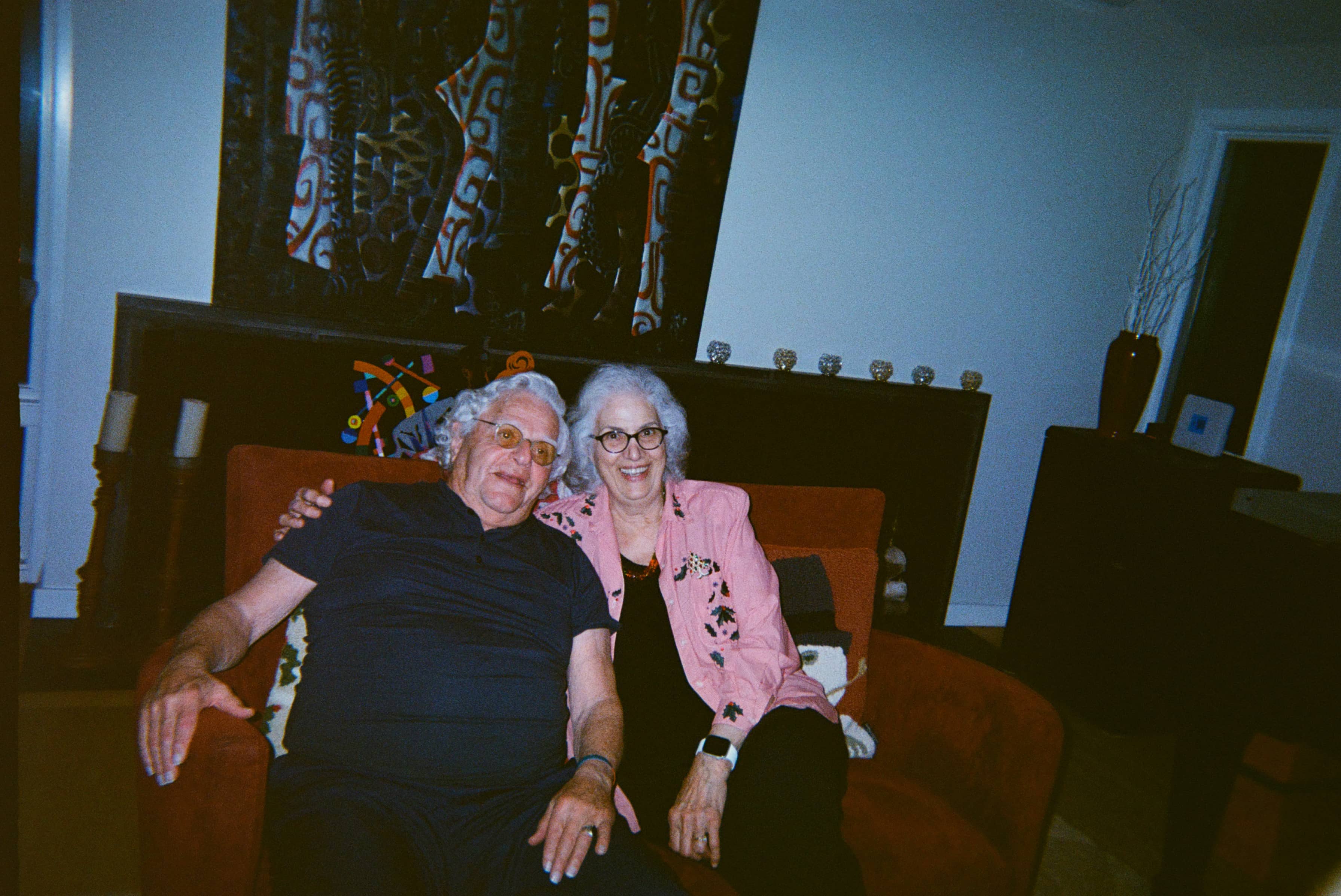 Two people seated smiling at the camera.