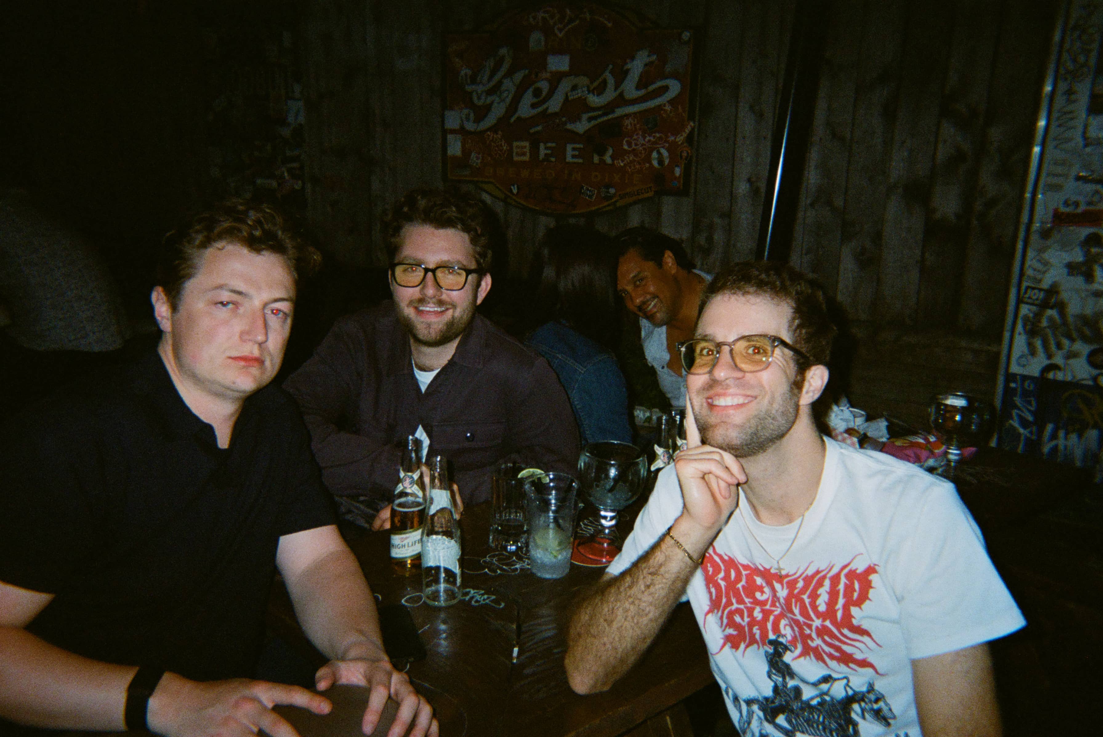 A group of men sitting at a table with drinks.