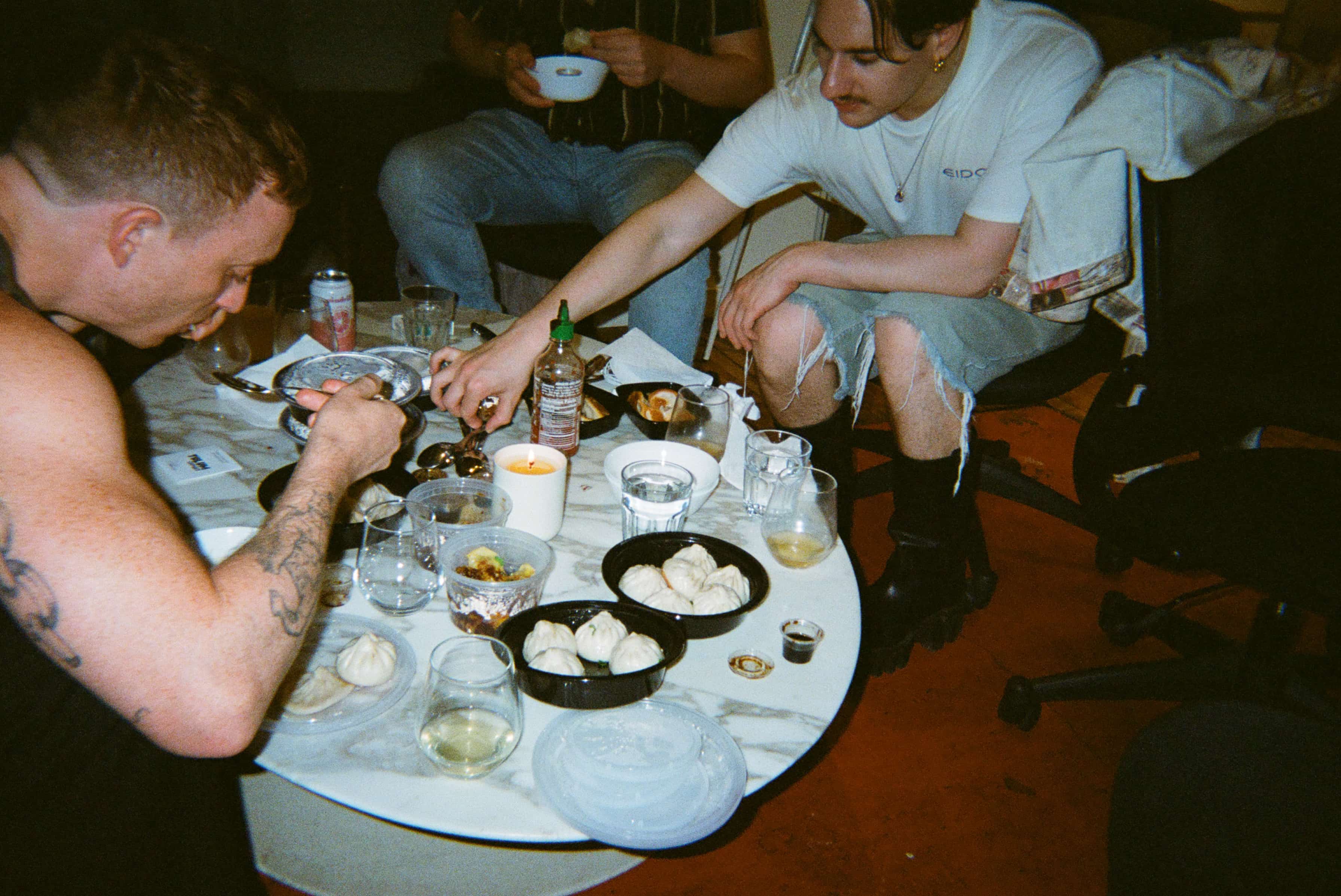 A group of people around a table with food.
